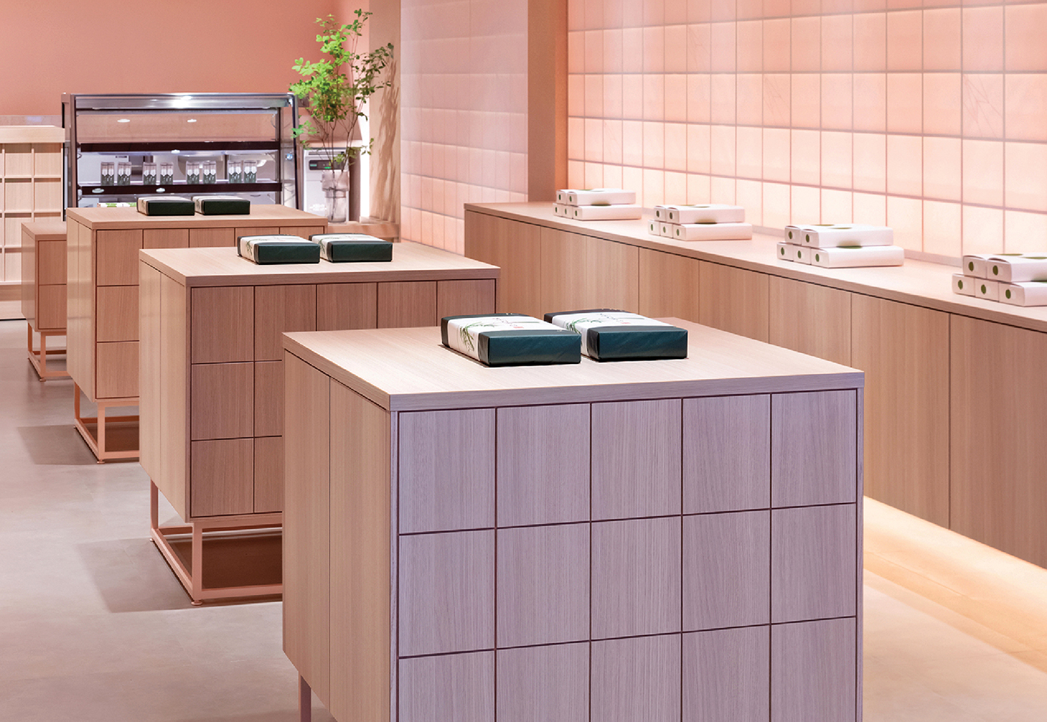 A kitchen with a counter and a microwave in a pastel pink retail store interior design