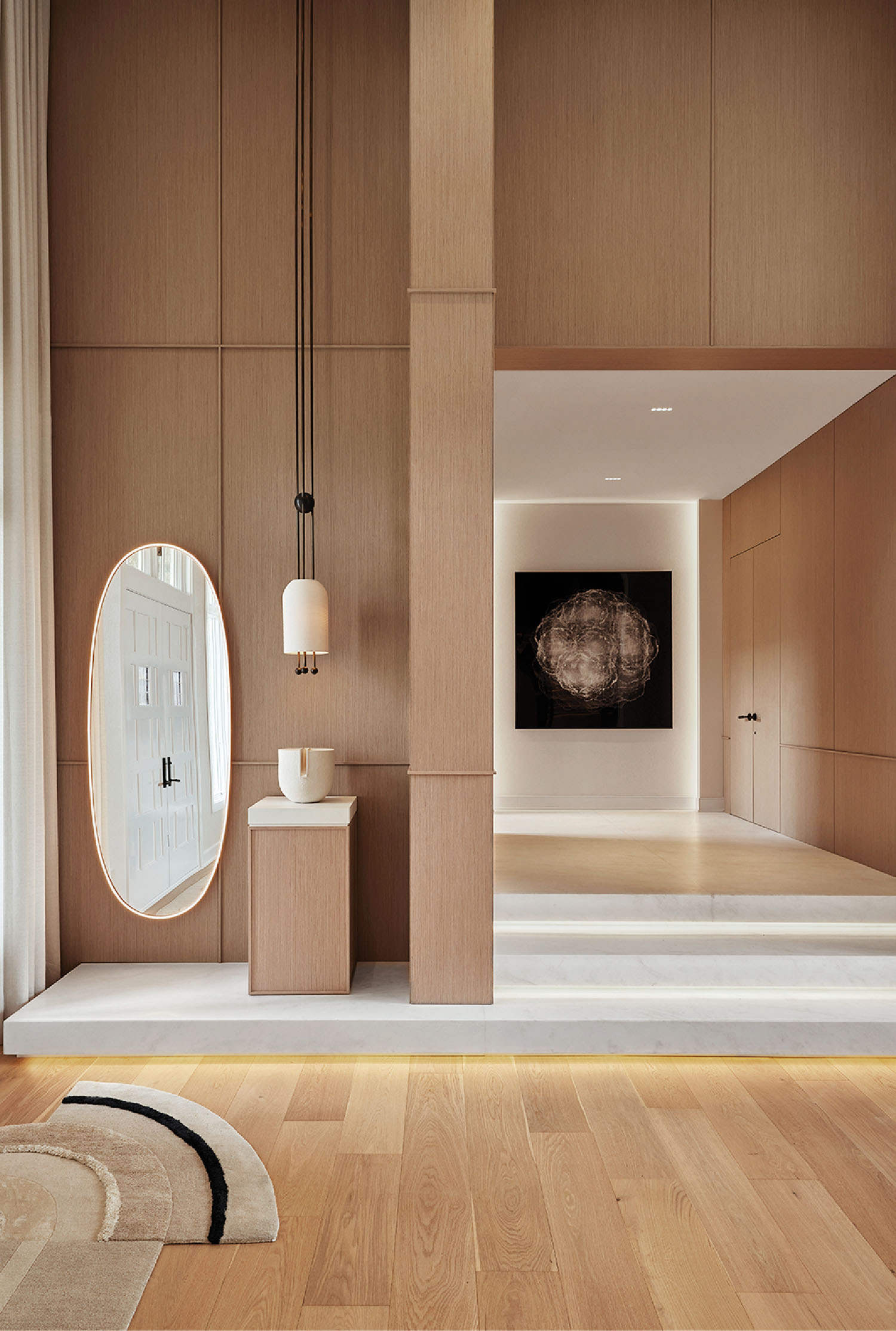 A room with a bed, a mirror and a chair